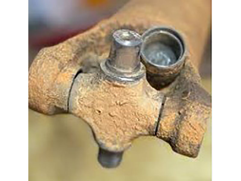 Rusty and brinelled U-joint cross from lack of grease and water intrusion showing metal wear and seal failure